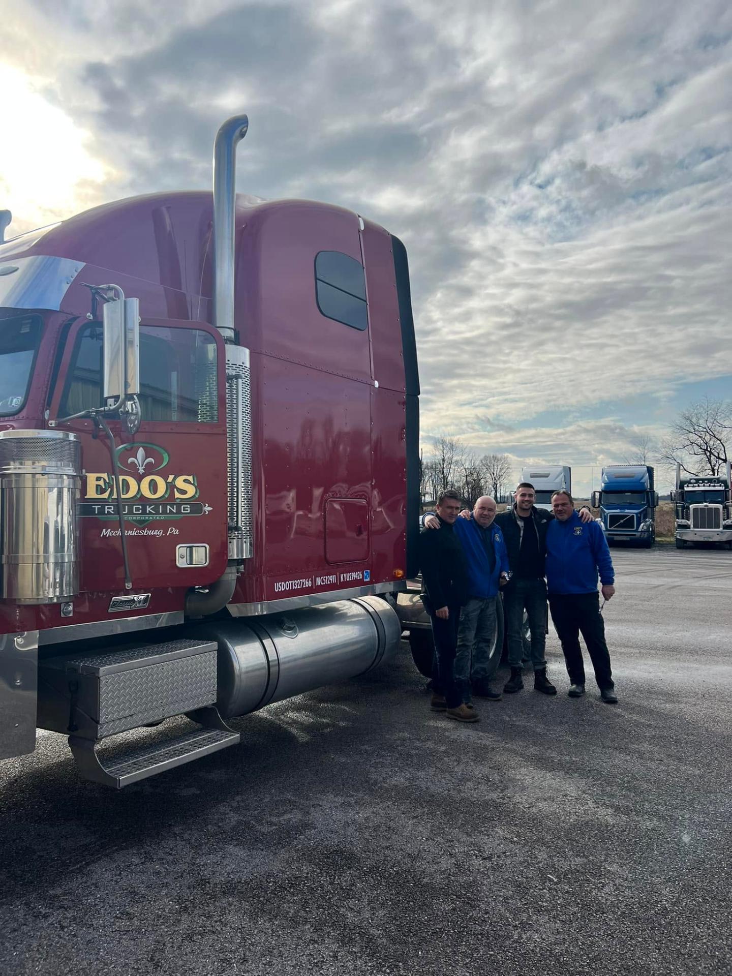 Professional CDL driver next to his truck